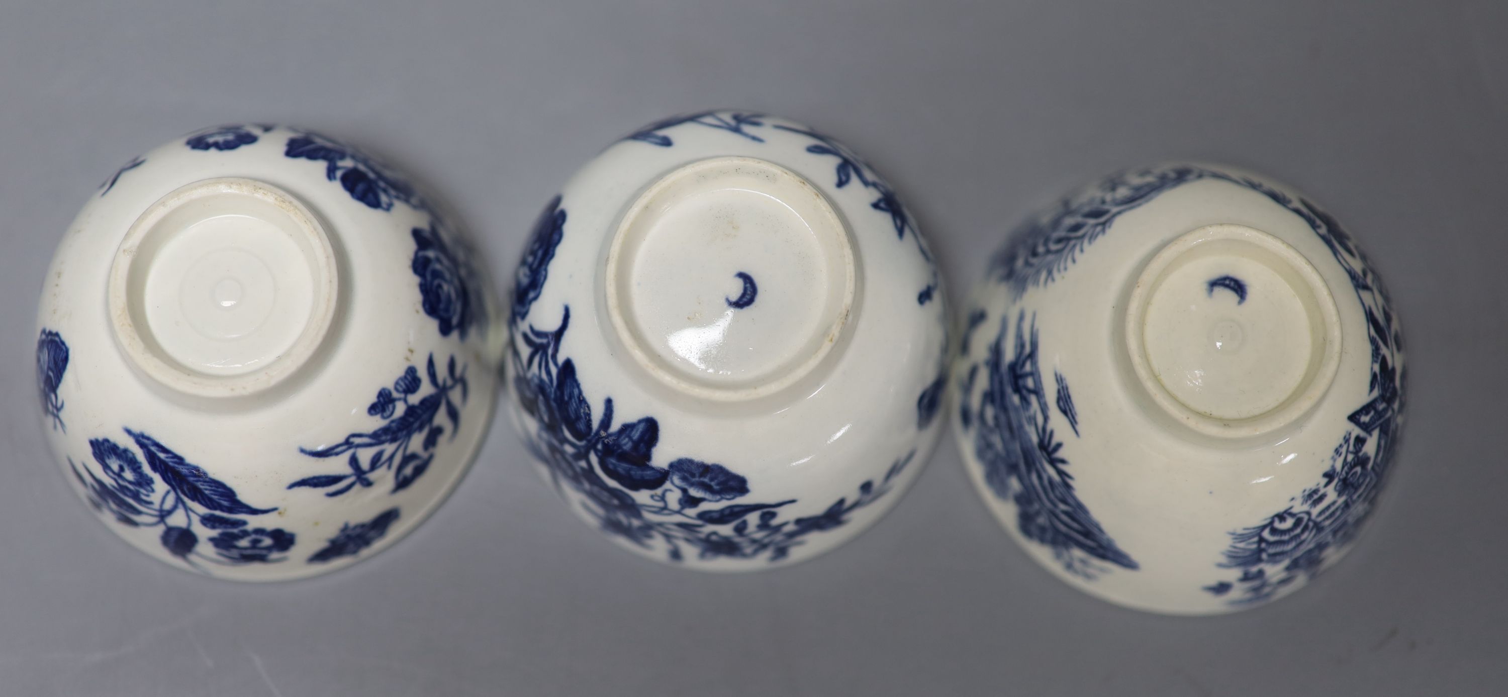 Three 18th century Worcester tea bowls and saucers, two printed with Three Flowers and one printed with the Fence pattern most with cre